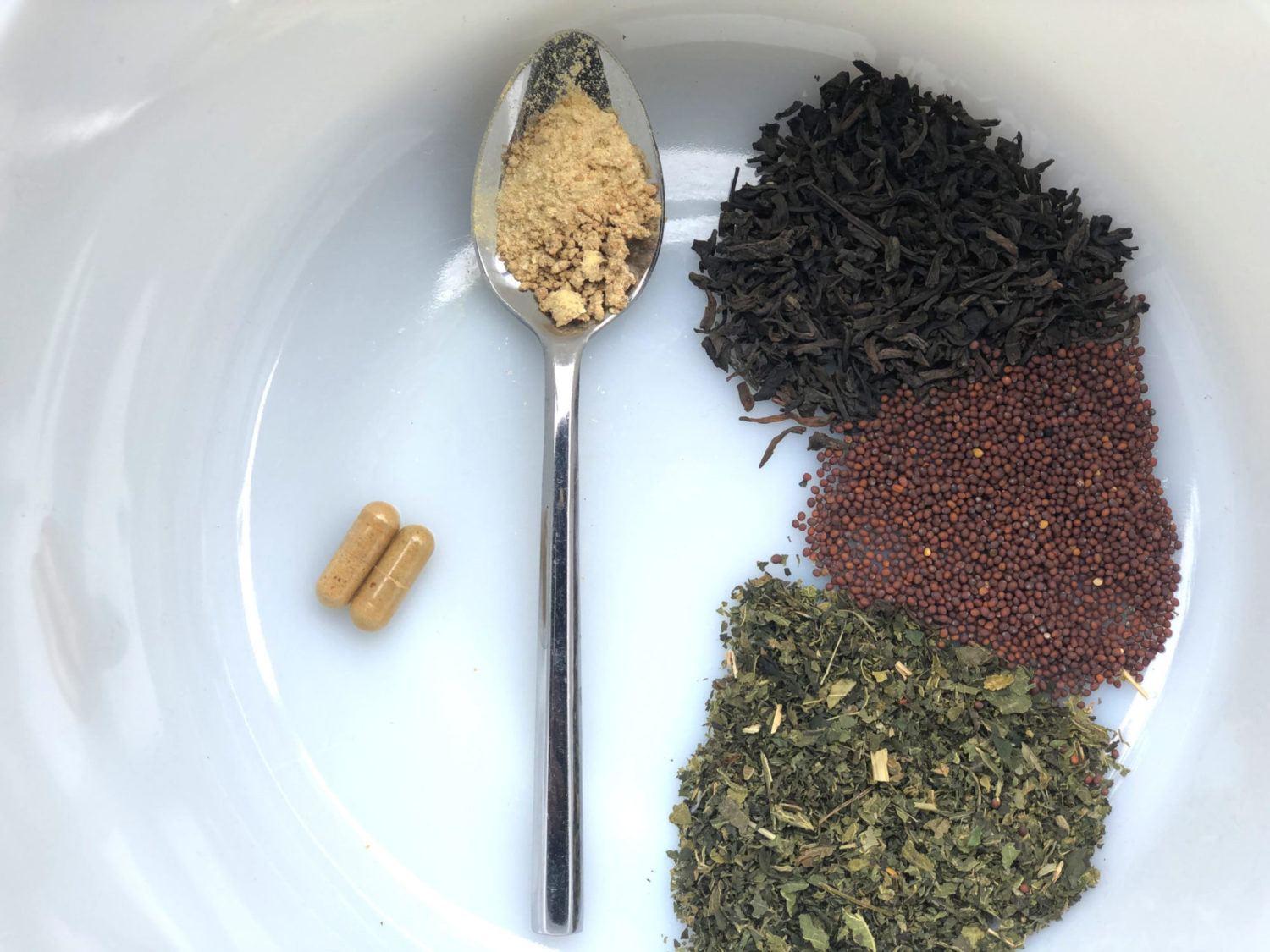 A Vivacity Acupuncture photograph showing different custom herbal formulations: two capsules on the left, a spoon with powdery granules in the center and whole herbs as a loose leaf blend on the right.
